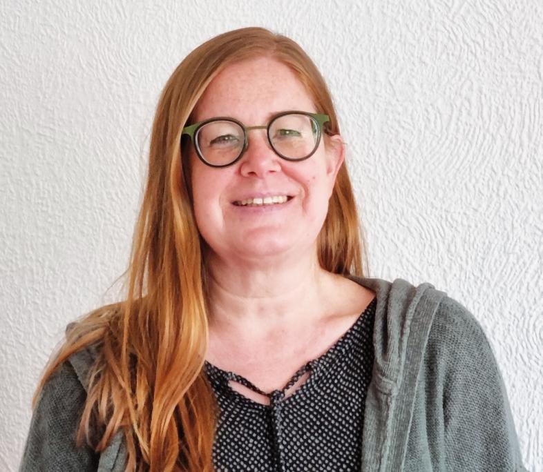Portraitfoto von Tanja Schapat, sie trägt ihr langes rötliches Haar offen.