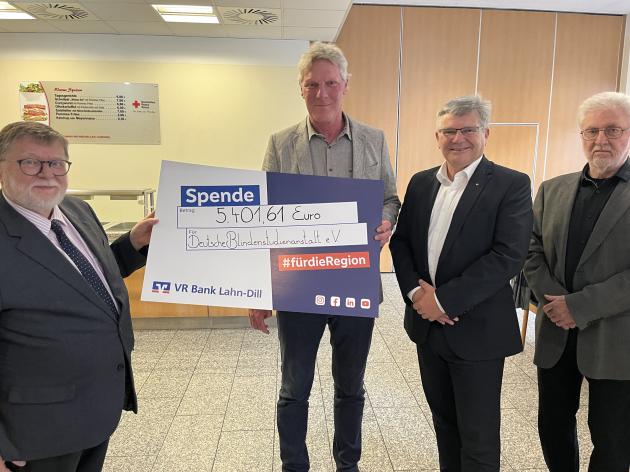 Die Veranstalter des Hungerlaufs mit Maarten Kubeja. Auf dem Foto hält Maarten einen Spendenschein über 5.400 Euro in der Hand, neben ihm drei Vertreter vom Lions Club.